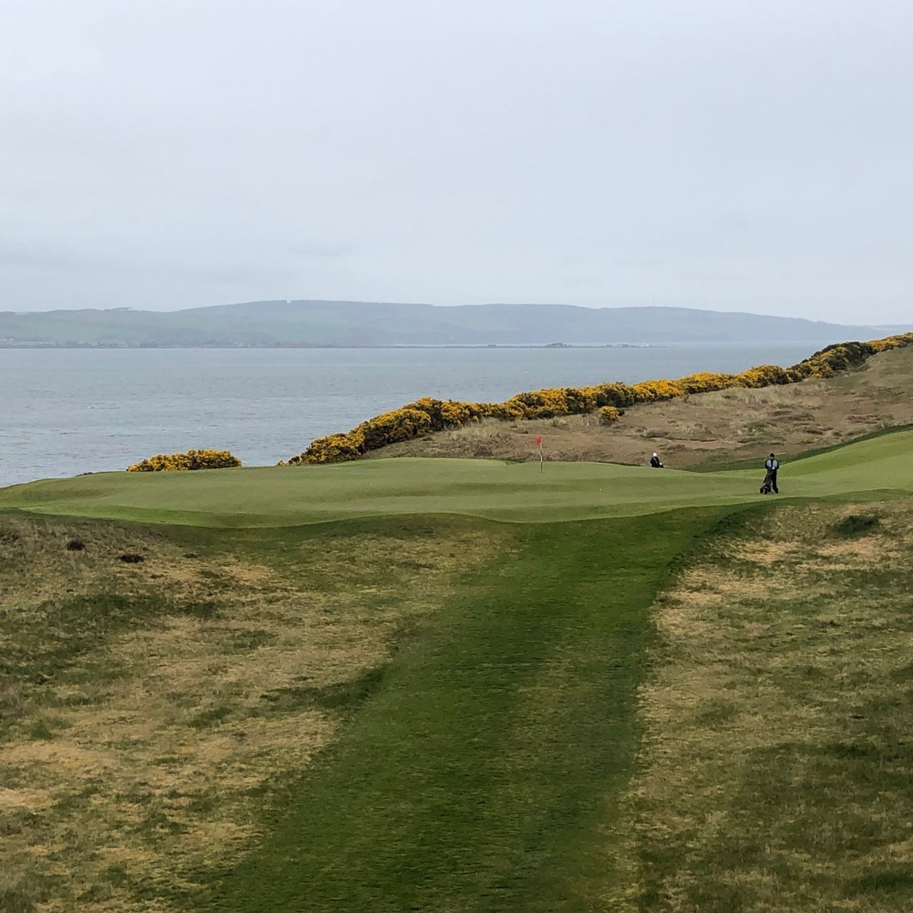 view of castle stuart golf course with ocean in background